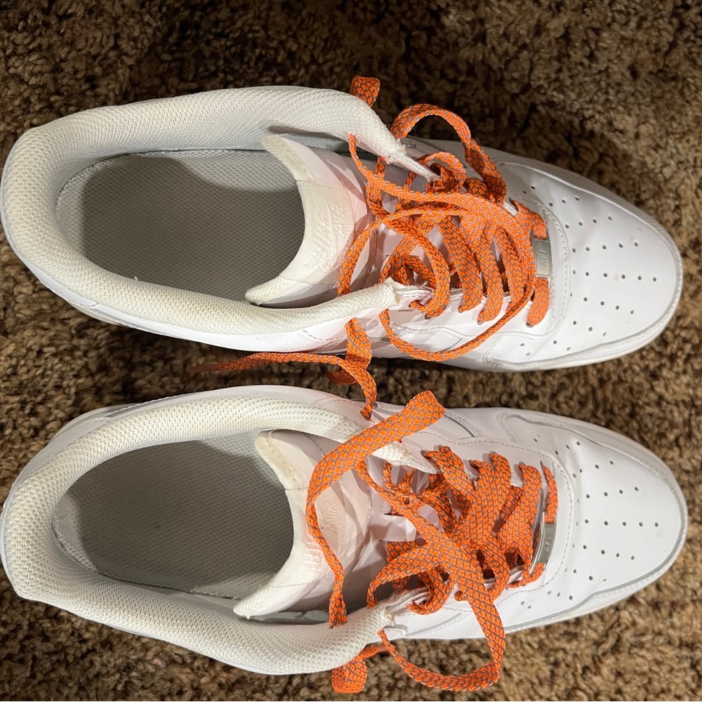 White Nike Air tennis shoes.